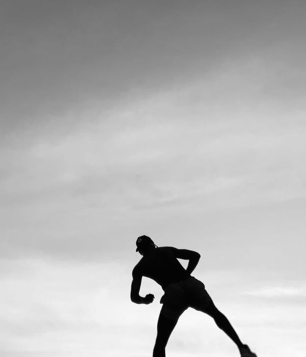 Athlete in a dynamic pose against a dark background.